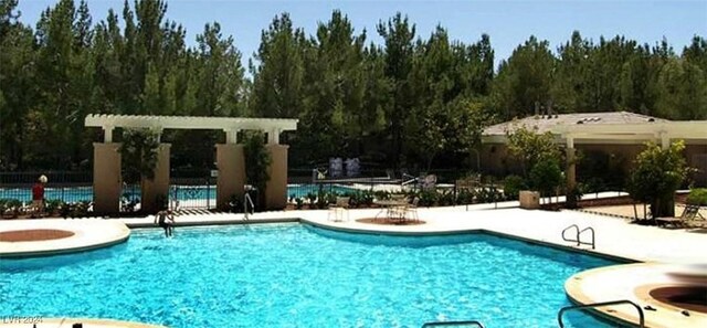 pool featuring a patio area and fence