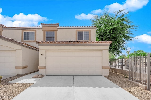 mediterranean / spanish-style home with a garage