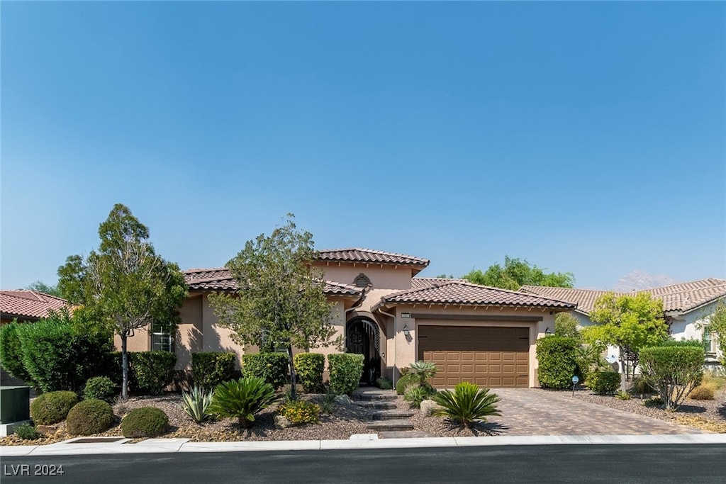 mediterranean / spanish home featuring a garage