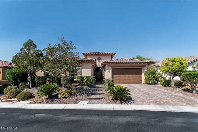 mediterranean / spanish house with a garage