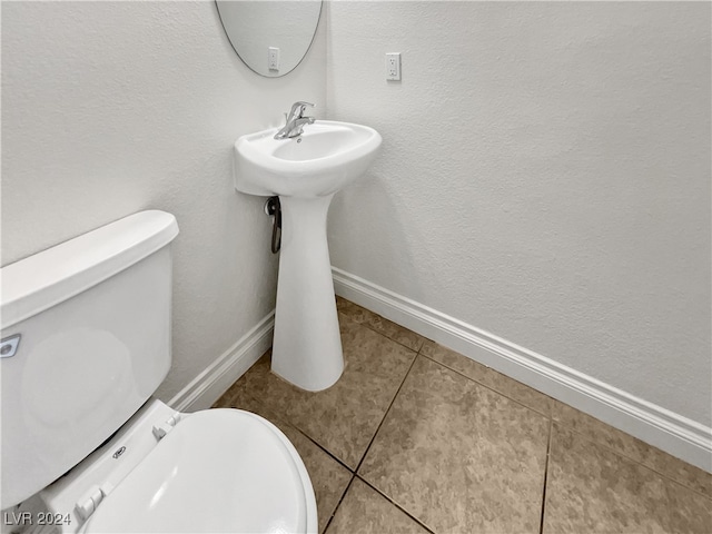 bathroom with tile patterned flooring and toilet