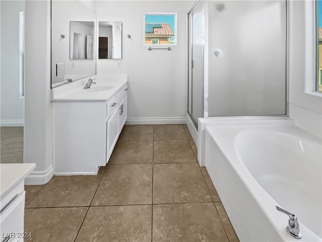 bathroom featuring independent shower and bath, vanity, and tile patterned flooring