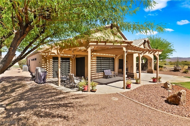 view of front of property with a patio and a pergola