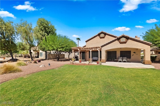 back of house with a yard, a pergola, and a patio area