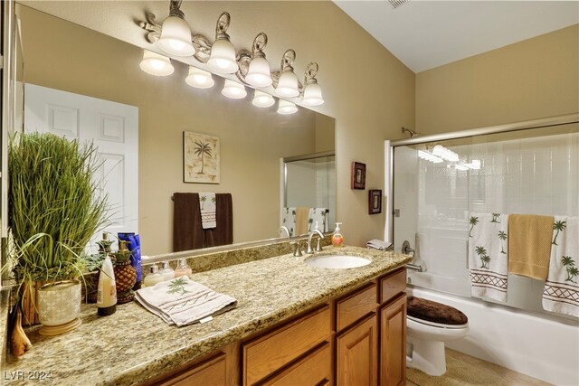 full bathroom featuring vanity, toilet, and combined bath / shower with glass door