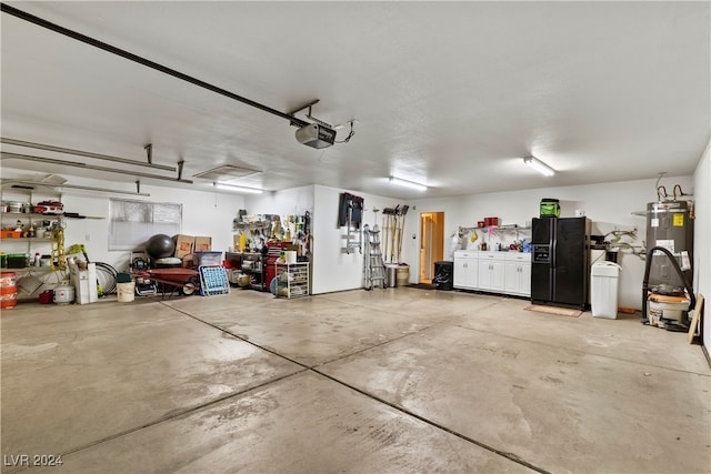 garage featuring water heater, a garage door opener, and black refrigerator with ice dispenser