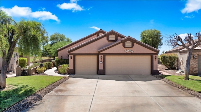 view of front of house with a garage and a front lawn