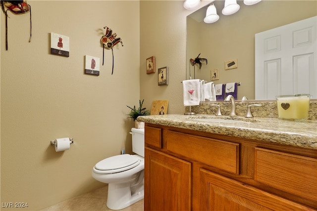 bathroom featuring vanity, toilet, and tile patterned floors