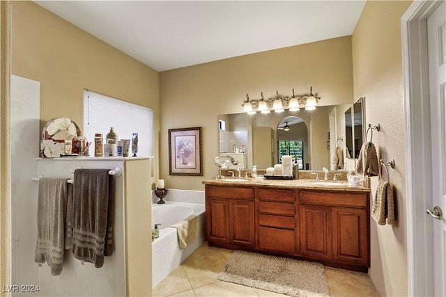 bathroom with tiled bath, vanity, and tile patterned floors