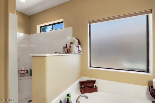 bathroom featuring separate shower and tub