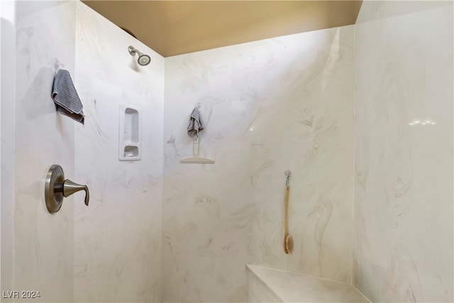 bathroom with a tile shower