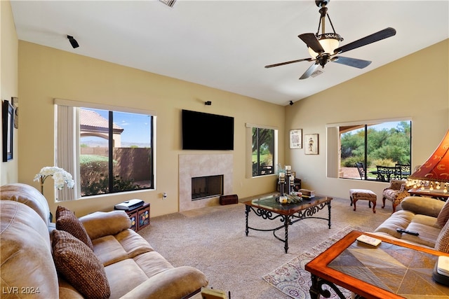 carpeted living room featuring ceiling fan, vaulted ceiling, and a high end fireplace