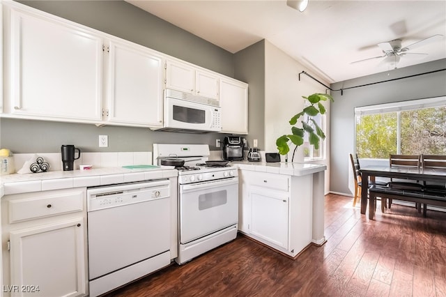 kitchen with ceiling fan, dark hardwood / wood-style flooring, white appliances, and white cabinets