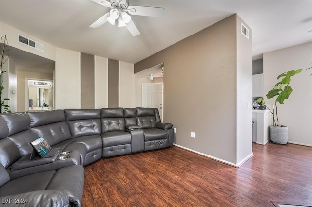 living room featuring dark wood-type flooring and ceiling fan