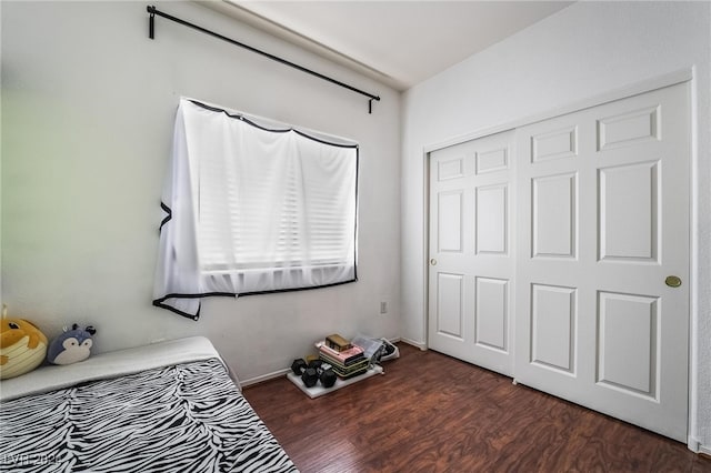 bedroom featuring dark hardwood / wood-style flooring and a closet