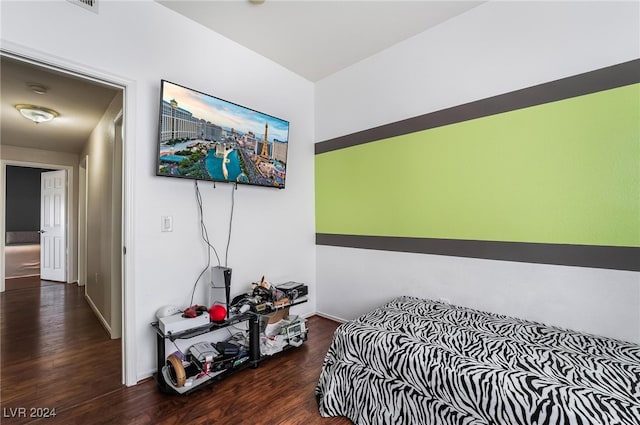 bedroom with dark hardwood / wood-style flooring