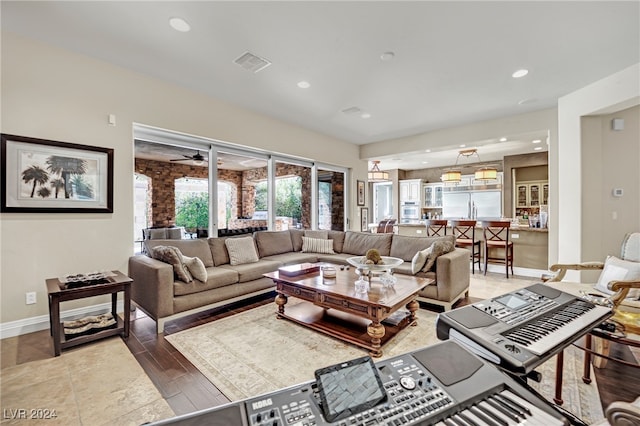 living room featuring wood-type flooring and ceiling fan