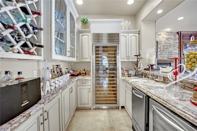 kitchen with beverage cooler, sink, and white cabinets