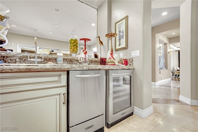 kitchen featuring light stone counters, wine cooler, light tile patterned flooring, sink, and dishwasher