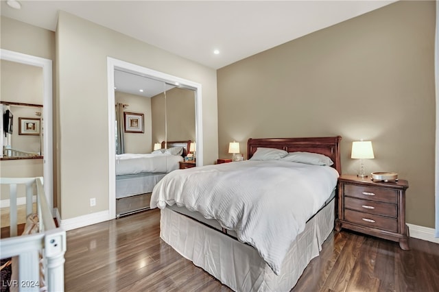 bedroom with dark hardwood / wood-style floors