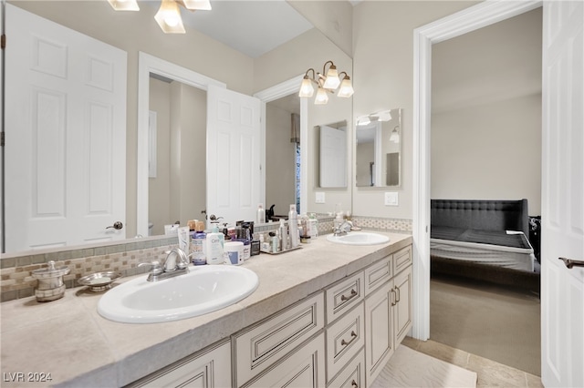 bathroom with tile patterned flooring, vanity, and tasteful backsplash