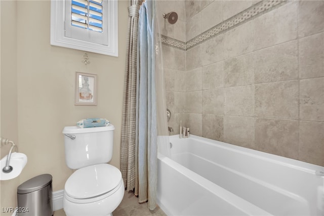 bathroom with shower / bath combo and toilet