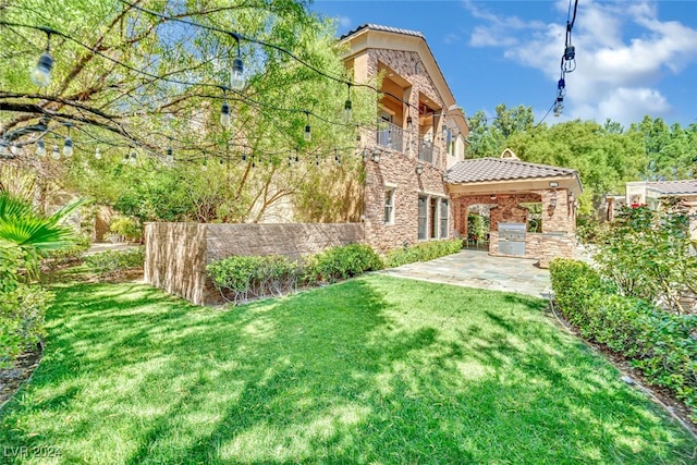 view of yard with a balcony and a patio