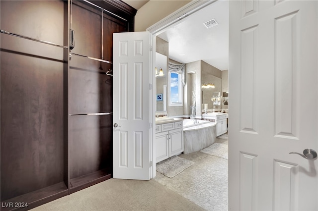 bathroom featuring vanity and a tub