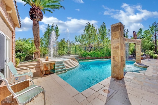 view of swimming pool with a patio and pool water feature