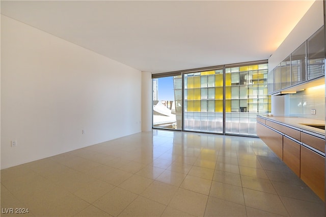 empty room featuring a wall of windows