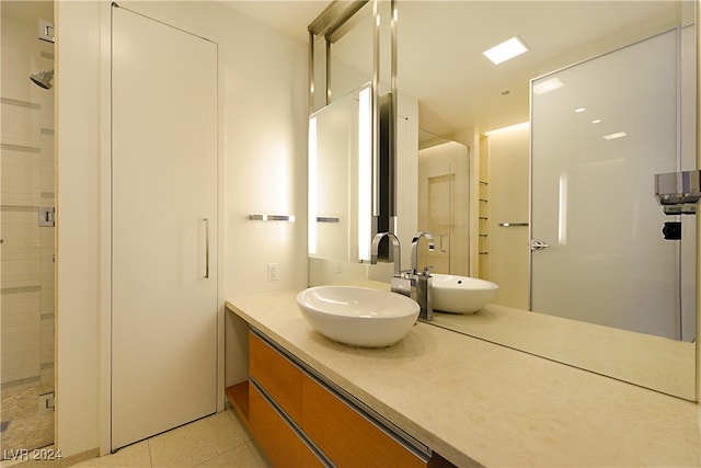 bathroom with vanity and a shower with shower door