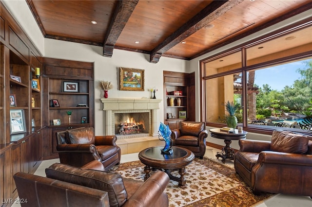 living room with wood ceiling, a tiled fireplace, and beamed ceiling