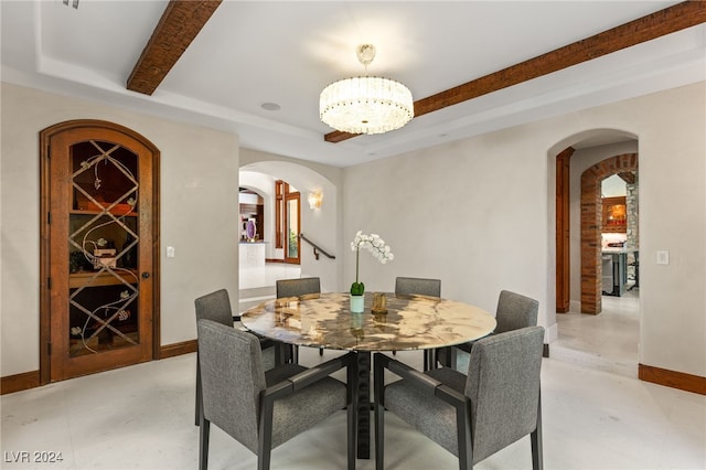 dining room with beamed ceiling and a notable chandelier