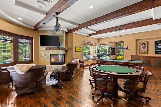 rec room with beamed ceiling, pool table, wood-type flooring, and a stone fireplace