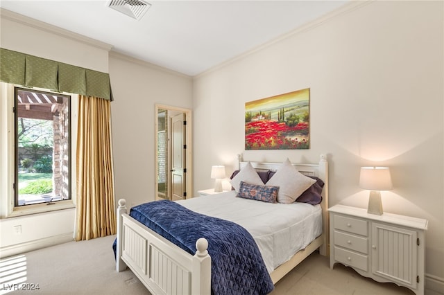 bedroom with crown molding and light carpet