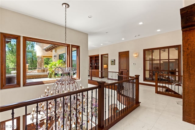 hallway featuring a chandelier