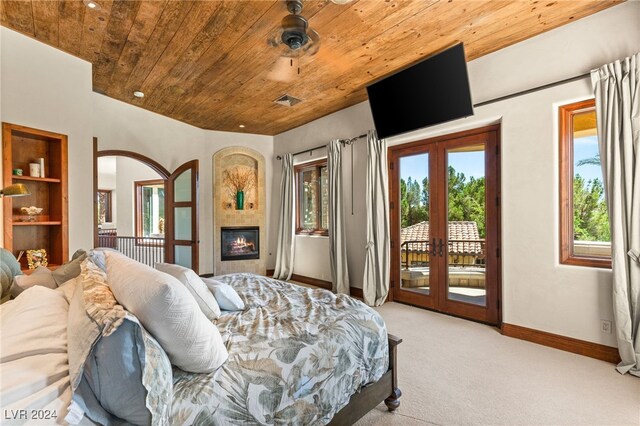 carpeted bedroom with access to exterior, wooden ceiling, and french doors