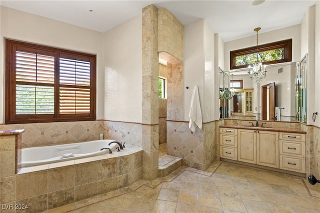 bathroom with plenty of natural light, vanity, a chandelier, and independent shower and bath