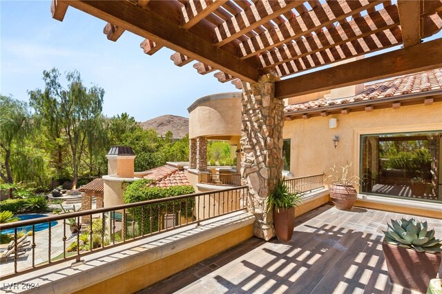 balcony featuring a mountain view and a pergola