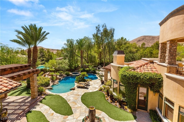 exterior space featuring a mountain view and a patio area