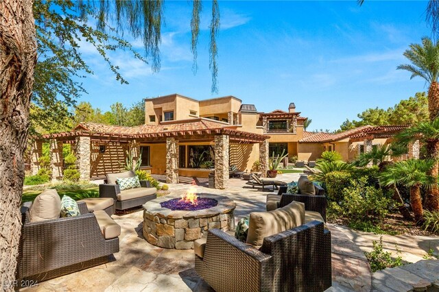 view of patio / terrace with an outdoor living space with a fire pit