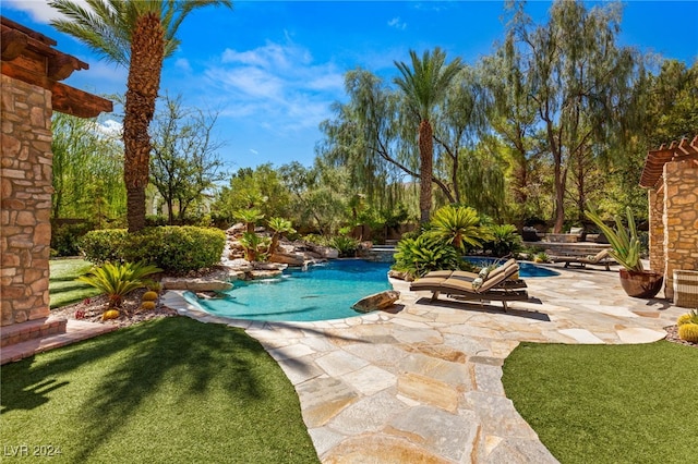 view of pool featuring a yard and a patio area