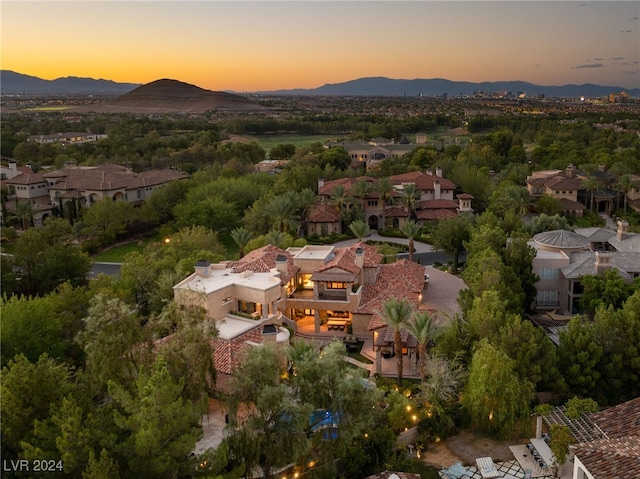 aerial view at dusk featuring a mountain view