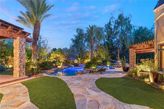 yard at dusk with a patio area