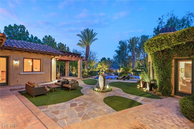 patio terrace at dusk with a pergola and an outdoor hangout area