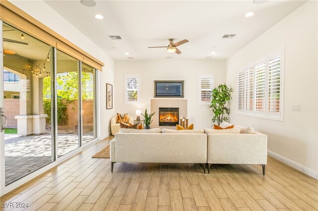 living room featuring ceiling fan and light hardwood / wood-style flooring