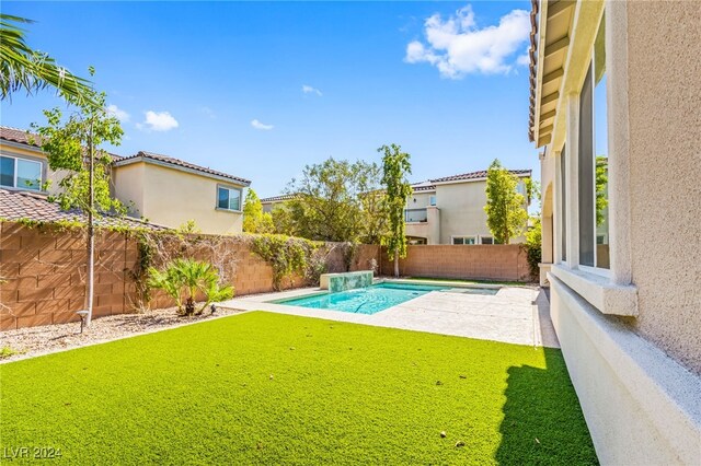 view of swimming pool with a yard and a patio