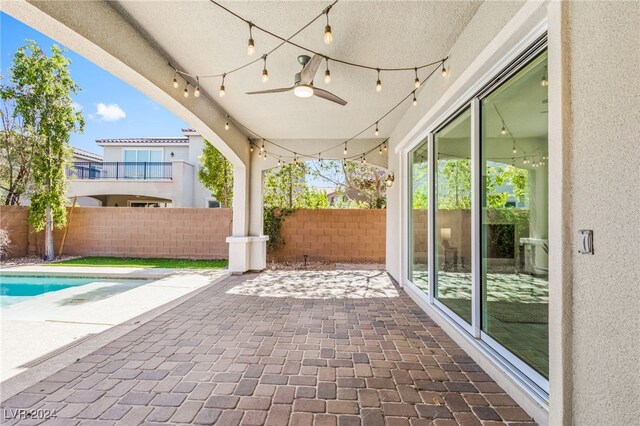 view of patio featuring a fenced in pool and ceiling fan