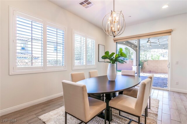 dining space with an inviting chandelier and light wood-type flooring