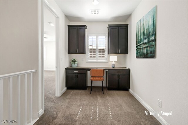 interior space with light carpet and dark brown cabinetry